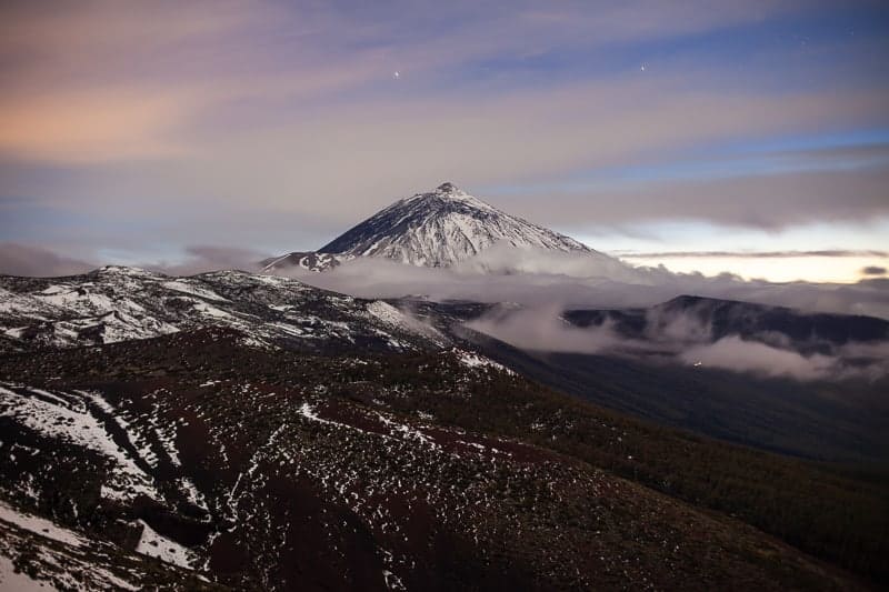 Sunset over snow volcano El Teide in winter. Nature landscape background