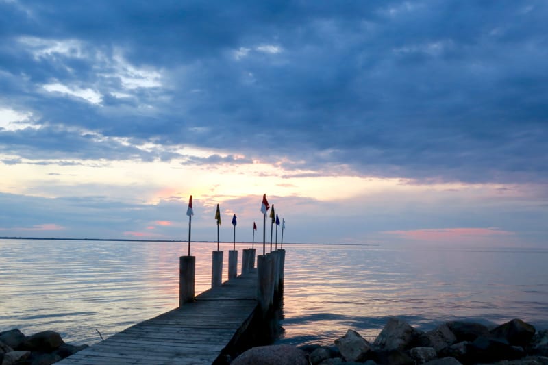 best places to visit in wisconsin during winter, pier leading into Lake Winnebago at sunset