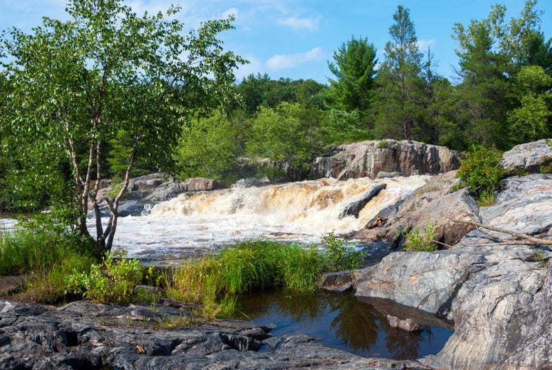 popular lakes in wisconsin, small waterfall feeding into a lake