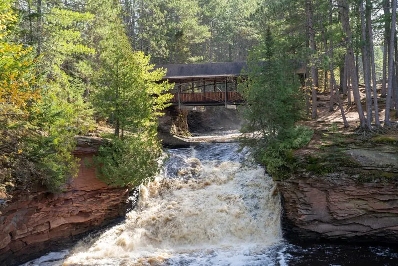Amnicon Falls State Park waterfall with a covered bridge, over the Amnicon River in Northern Wisconsin