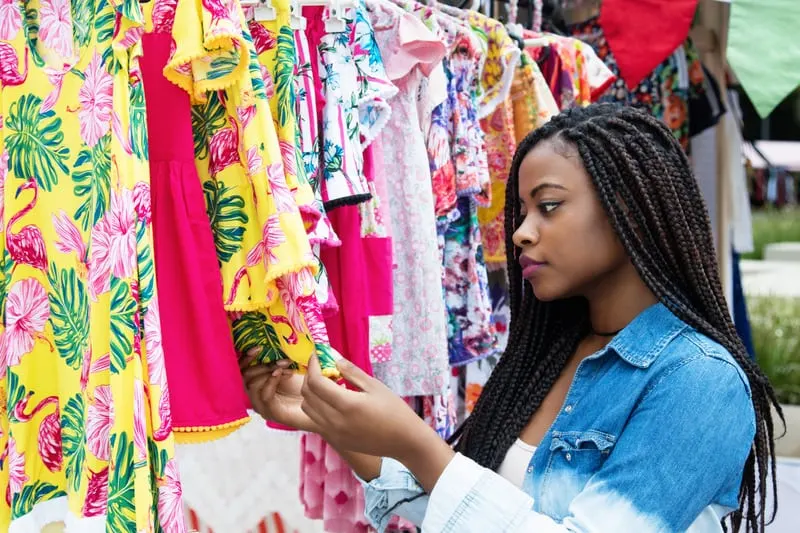 African american woman shopping colorful clothes outdoors at typical traditional market, cabo verde, cape verde holidays, vacation, travel