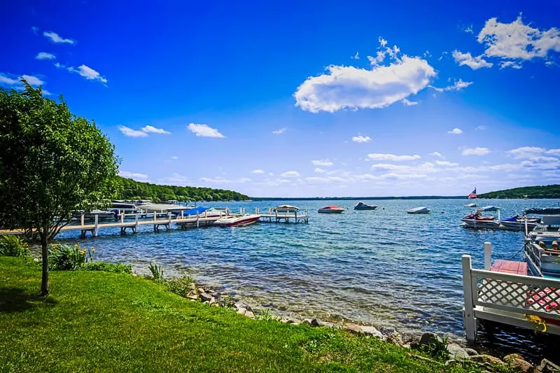 romantic getaway in lake geneva, wisconsin, lakeside view of pier on lake geneva under a bright blue sky with clouds