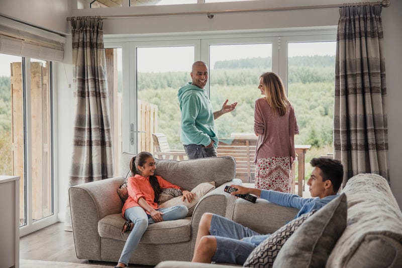 a family of four enjoying their time talking in the living room