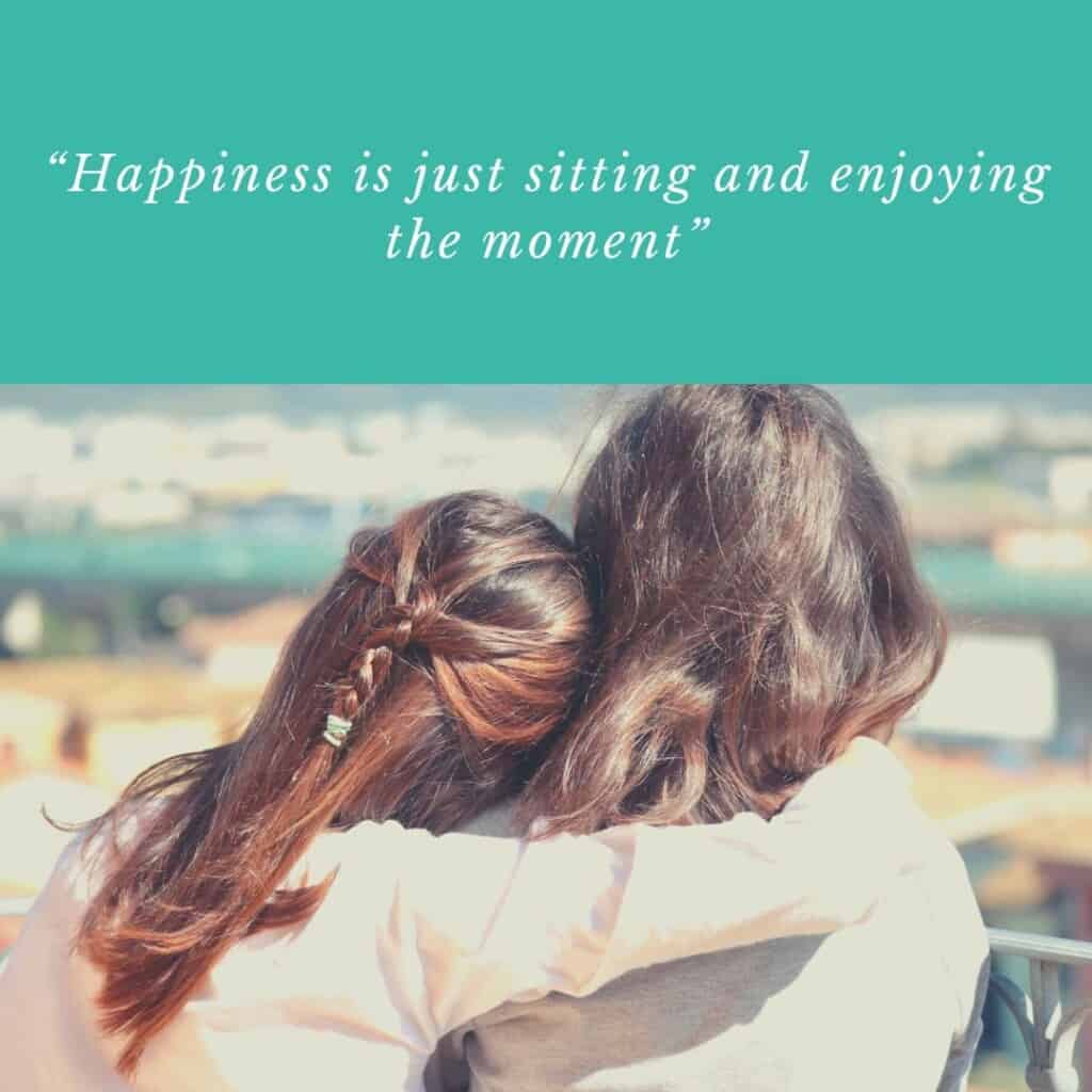 Happiness is just sitting and enjoying the moment; two people looking from a rooftop side hugging