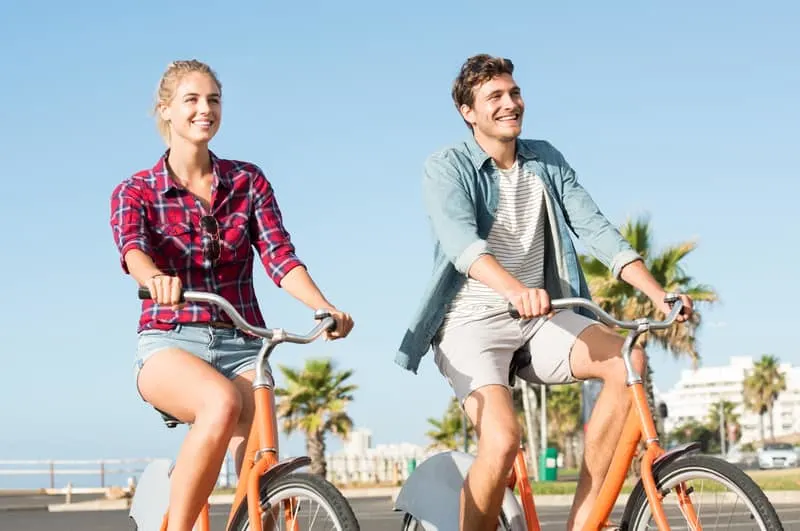 fun things to do in Apostle Islands, WI, Young couple riding bikes during summer vacation.