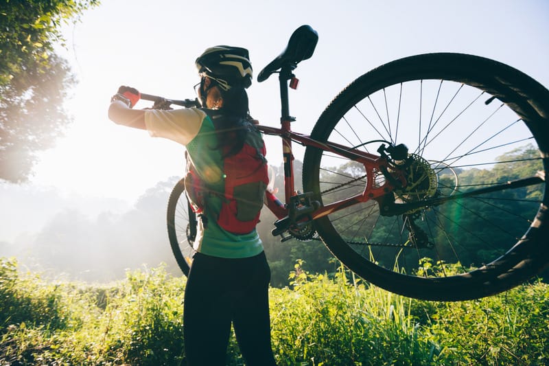 things to do in central wisconsin for nature lovers, woman carrying her bike