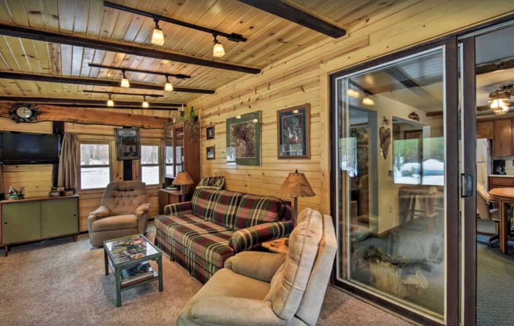 an interior of a beautiful cabin livinf room with wood-accents and materials located in State Forest in Wisconsin