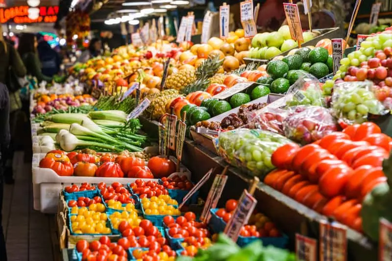 downtown appleton Wisconsin, Vegetable and fruit stalls in Farmers Market with a large display of colorful produce including tomatoes, peppers, spring onions, avocados, zucchinis and more