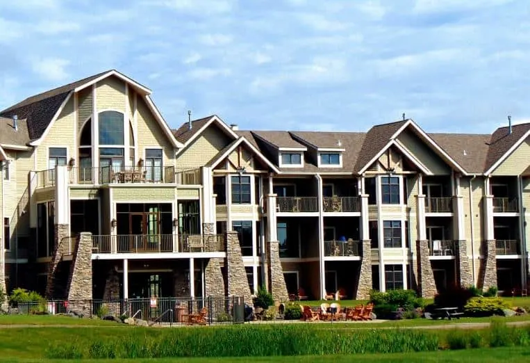 best resorts in wisconsin for families, exterior view of northernaire resort shows three floors of rooms with balconies