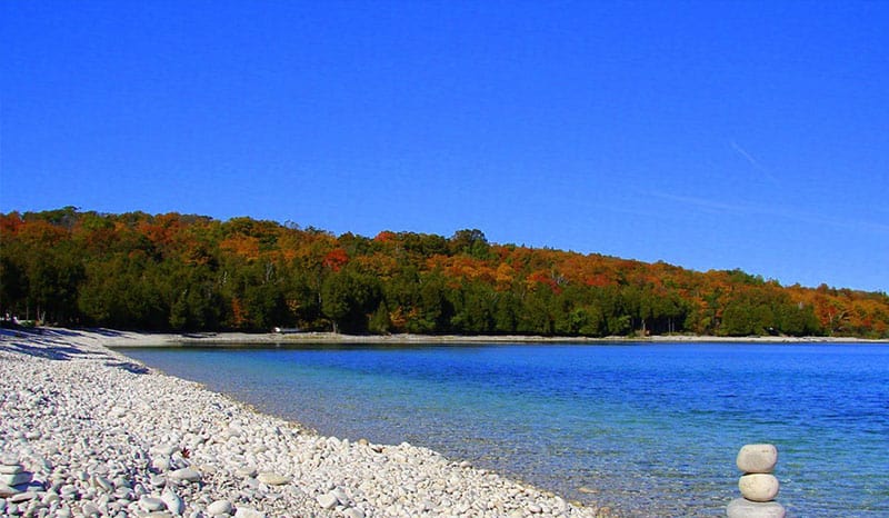 Cool Beaches in Wisconsin, best blue sky with green forest view in Schoolhouse Beach, Washington Island