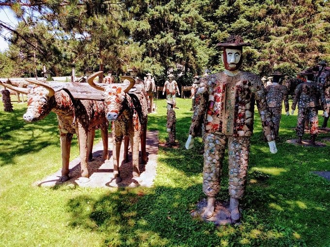 Cool things to do in Northern Wisconsin, Statue of a man wearing a cap and a Statue of bullcart