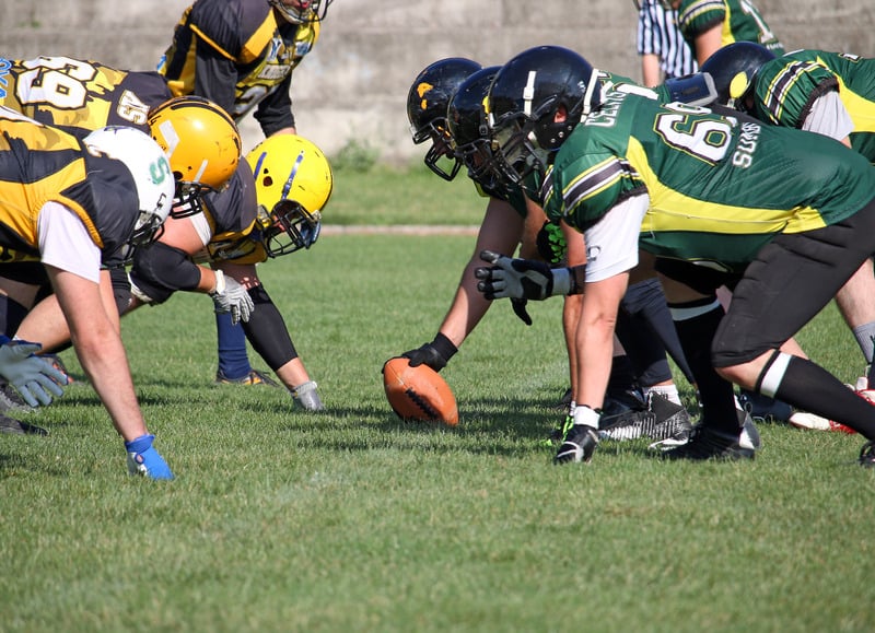 Check out these things to do in fall in northern wisconsin, close up shot of football players squaring off against each other and about to resume play