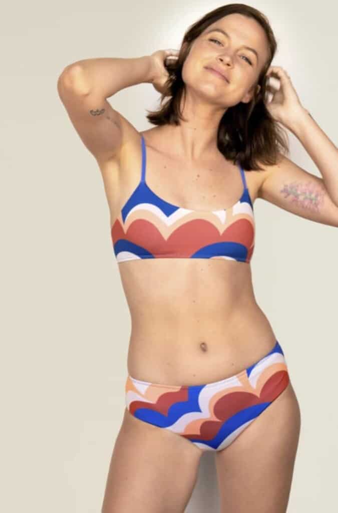 woman wearing multi-colored ethical swimwear from outerknown