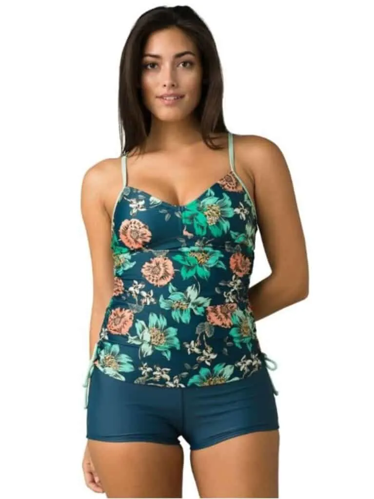 woman wearing swimming top with flower pattern and swim shorts; affordable eco friendly swimwear