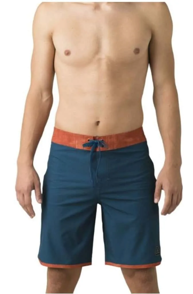man in blue swim trunks from rei; top sustainable swimwear brands