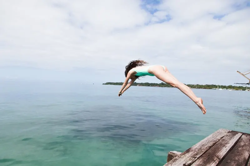 ethical swimwear- Photo of Woman Diving Into the Water, eco friendly swimwear brands