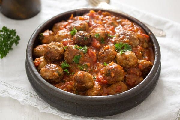 Albondigas dish on table covered in white tablecloth