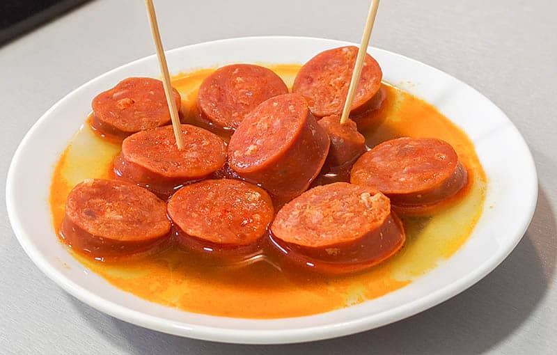 Cider Chorizo dish from Asturias on a plate with toothpics