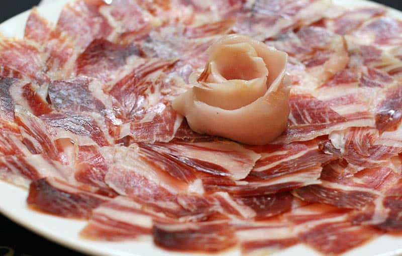 Enjoy some of the typical food in Spain, Spanish Cured Ham dish arranged in a spiral on a plate