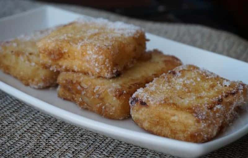 Find the joy of the food of Spain, Leche Frita dish sitting on white rectangular plate