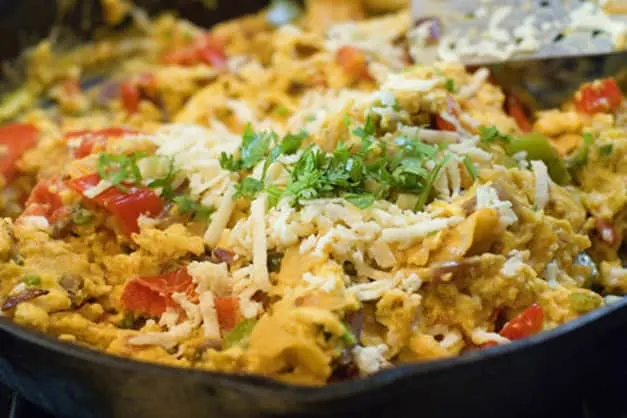 Try out some Spanish food names at your next Spanish meal, close up shot of Migas dish in metal skillet