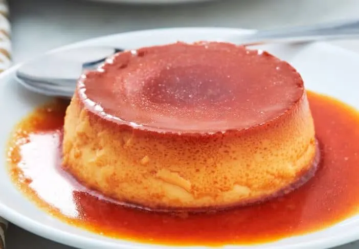 Best Spanish Sweet Snacks, flan on a plate with a spoon