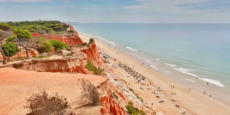Best Beaches in Algarve, people relaxing on Praia da Falesia in Albufeira