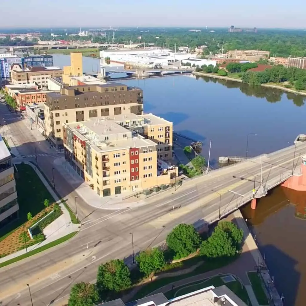 an aerial view of a city with buildings with a river running through it