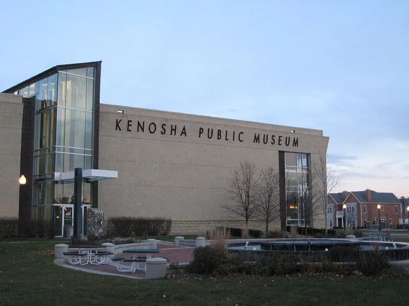 front view of kenosha public museum wiith a small park at the front