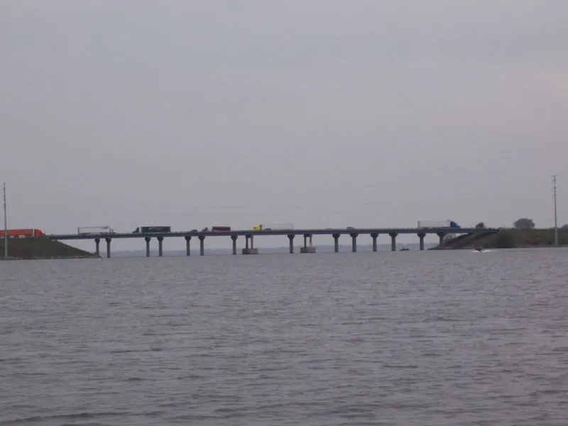 Don't miss these things to do near appleton wi, view of bridge crossing Little Lake Butte des Morts with several goods vehicles driving across on a grey day