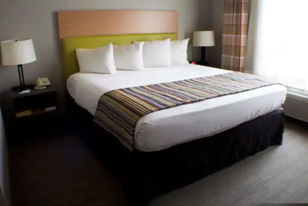 Get involved in these things to do near appleton, wi, interior of hotel room at the radisson blu appleton with neatly made double bed complete with four soft pillows and bedside table with a bedside lamp either side