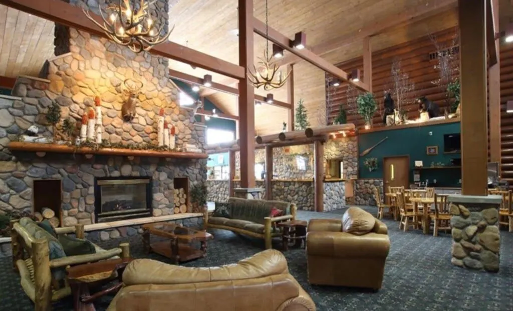 Lose yourself in some romantic fall getaways in Wisconsin for couples, interior of resort with high beams, couches and stone walls