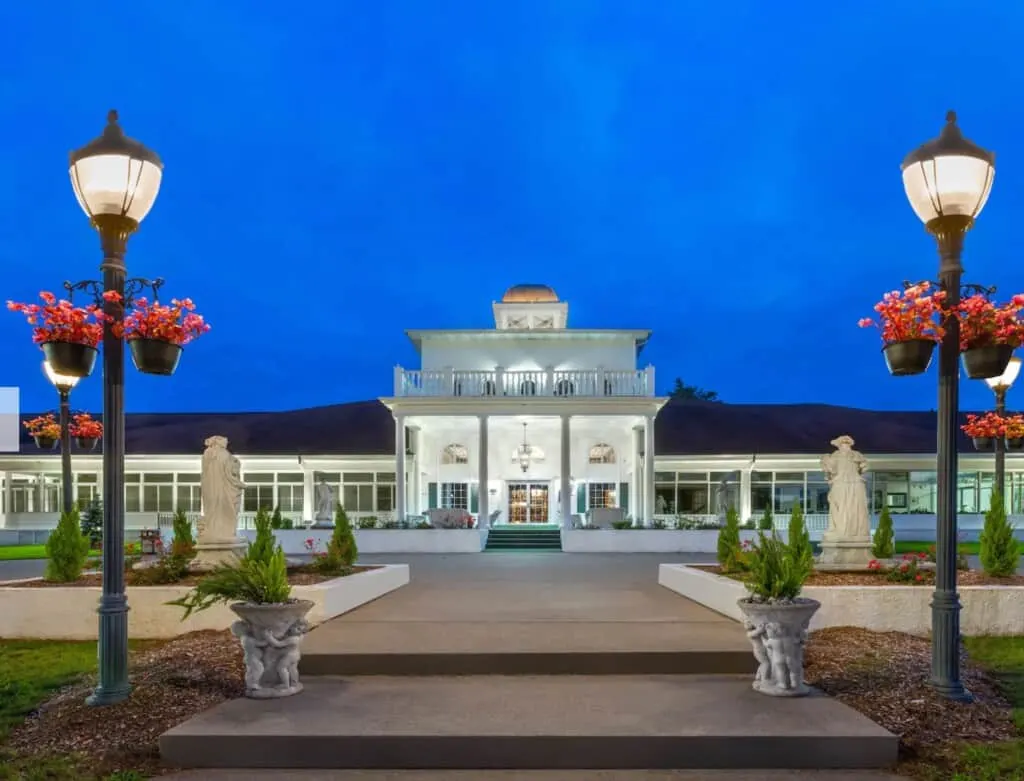 romantic getaways in wisconsin with pool in-room, exterior of wyndham four seasons island resort lit up at night
