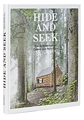 Nature coffee table books, book cover showing modern design wooden cabin surrounded by tall trees in the mist