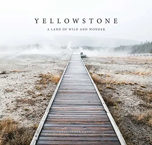 Yellowstone book, book cover showing wooden boardwalk path leading into misty distance across sandy brushland