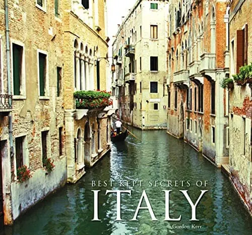 Coffee table books Italy, book cover showing canal running between old Italian buildings with small balconies and window baskets full of lush green plants