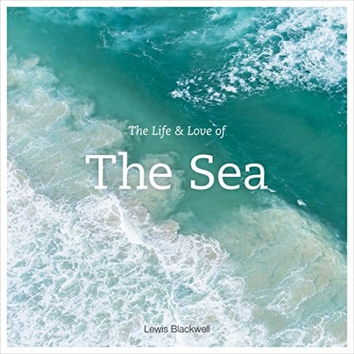 Coffee table travel books, book cover showing the white surf of the sea crashing against a wave of turquoise water