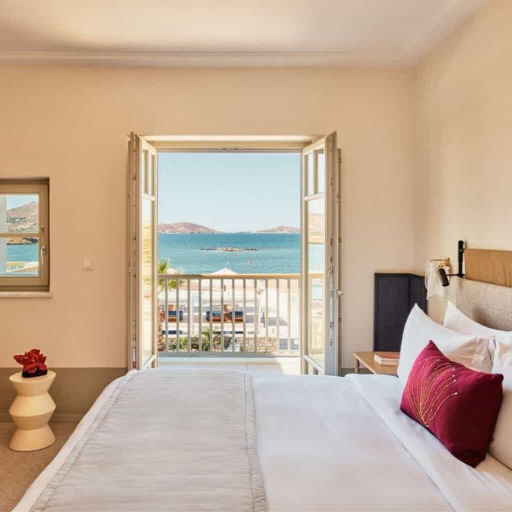 a hotel bedroom room at Cosme Resort with a view of the ocean from the door or balcony