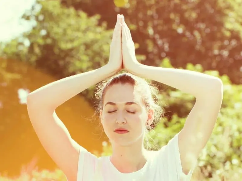 best Madison, WI, things to do, woman meditating with hands above head