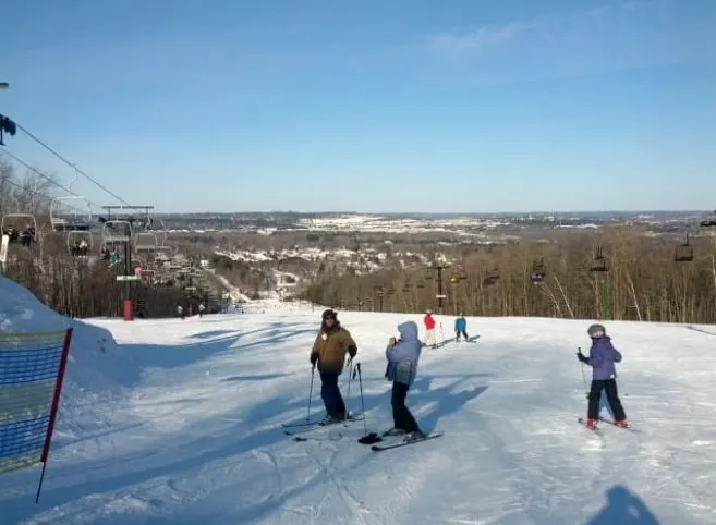 Spend fall at these ski resorts in wisconsin dells, View of people skiing in the snow on Granite Peak Ski Resort, Rib Mountain