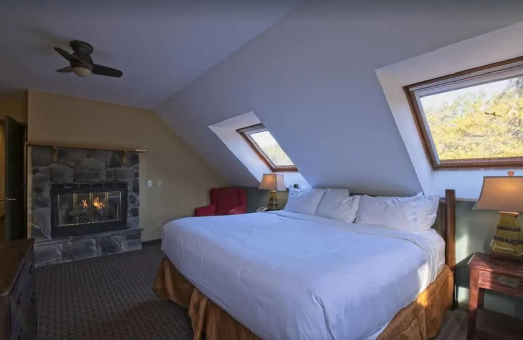 a bedroom with a fireplace on an attic in a cabin at wisconsin dells