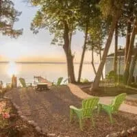 a view with sunset on the lake from a small garden with chairs. Best Lake Cabins in Wisconsin