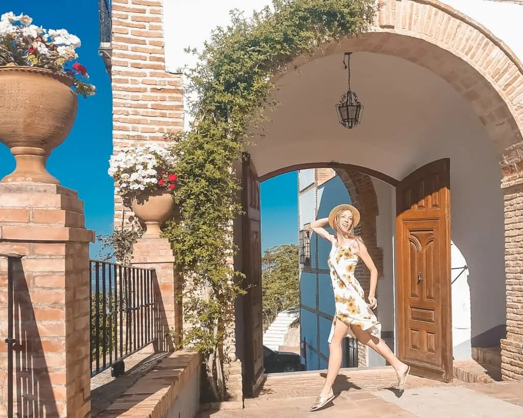 spain travel blogger, a happy woman on an entrance