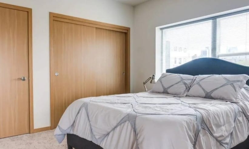 Best Milwaukee Airbnb for Solo Travelers, bedroom view of  Modern Downtown Apartment with Balcony