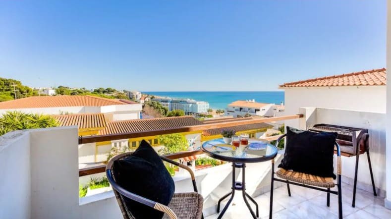 Best Algarve Airbnb in Albufeira, Balcony view of Sea View Apartment with two chairs and table