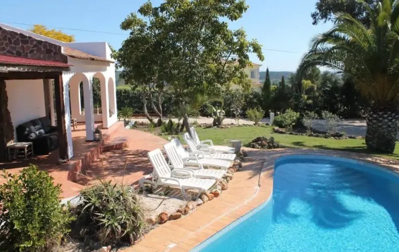 Best Algarve Airbnb For Families, Pool side view and garden of A Traditional Portuguese Villa