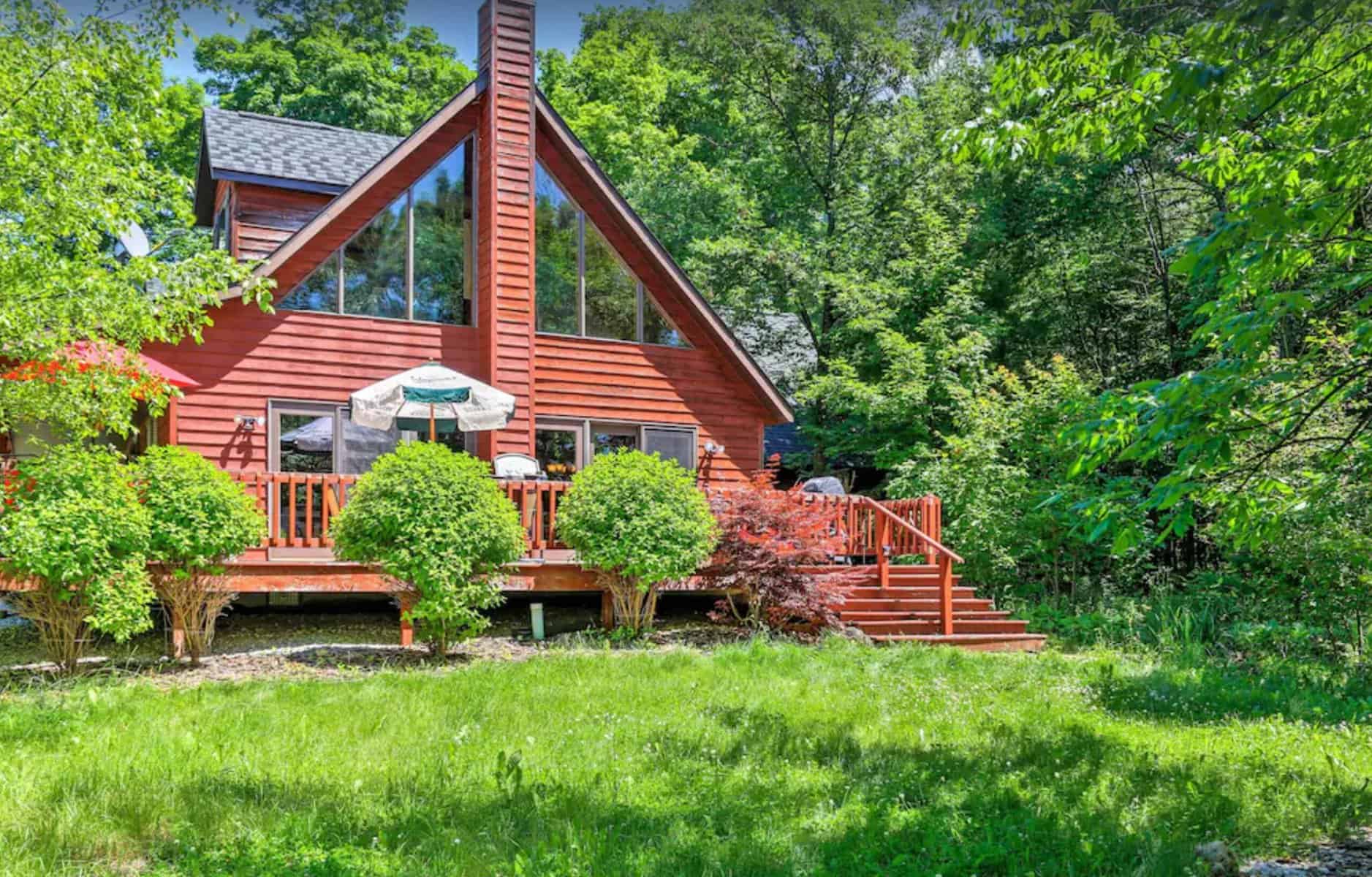 an exterior of a luxurious log door county cabin in the woods