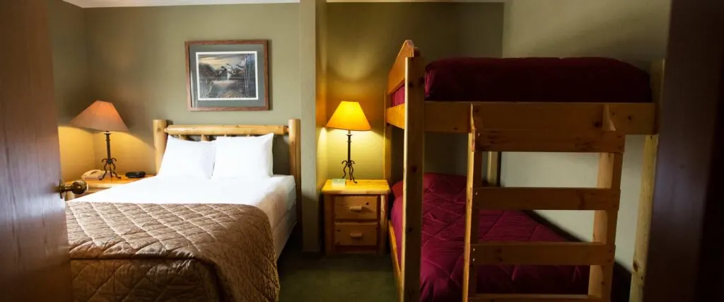family vacation ideas wisconsin, hotel room with queen bed and bunk beds for kids at Cranberry County Lodge, Wisconsin