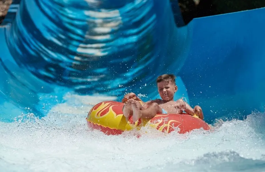 a boy tubing down a waterslide at waterpark, lake geneva wisconsin