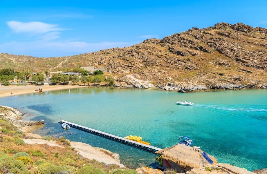 the best Paros beaches, Inlet of Monastiri Beach with clear water and boat driving towards the shore
